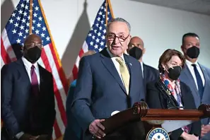  ?? Associated Press ?? ■ Senate Majority Leader Chuck Schumer, D-N.Y., speaks to reporters alongside, from left, Sen. Raphael Warnock, D-Ga., Sen. Cory Booker, D-N.J., Sen. Amy Klobuchar, D-Minn., and Sen. Alex Padilla, D-Calif., during a press conference Tuesday regarding the Democratic party’s shift to focus on voting rights at the Capitol in Washington.