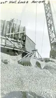  ?? ST. CATHARINES MUSEUM, MADELEIN MUNTZ COLLECTION ?? A clamshell bucket hoists gravel for breast wall constructi­on at Lock 2 in March 1915.