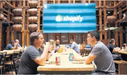  ?? COLE BURSTON BLOOMBERG ?? Employees in a common area at Shopify Plus in Waterloo. Shopify Inc. is expanding in Vancouver. “It’s our intention to make a long-term commitment to the city,” said company vice-president Lynsey Thornton.