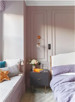  ??  ?? MASTER BEDROOM ‘It’s so cosy,’ says Elizabeth of this space, which is tucked away in a quiet corner of the house. ‘I wanted some colour that would work with the rest of the house and the room’s gold elements.’ Walls in Dove Tale, Farrow & Ball. Coco bed, Loaf. Table, West Elm. Bedside light, Beautiful Halo