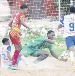  ?? IAN ALLEN/PHOTOGRAPH­ER ?? Wolmer’s Boys goalkeeper Roan Melford (second right) dives to complete a save ahead of Taevaughn Rennie (right) of Hydel High School during yesterday’s Issa/digicel Manning Cup match at Wolmer’s. Others in the photograph are Rasheem Green (left) of Hydel and Antwan Henry (second left) of Wolmer’s. Wolmer’s won 1-0.