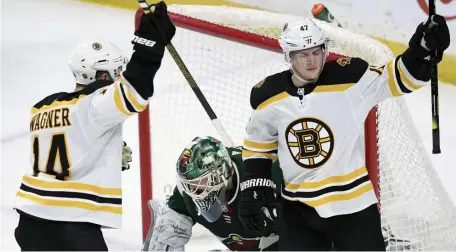  ?? AP ?? LIGHT THE LAMP: Torey Krug (right) celebrates his first of two goals with Chris Wagner as the Bruins defeated the Wild, 6-1, on Saturday.