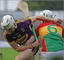  ??  ?? Rory O’Connor beats Carlow centre-back Eoin Redmond.