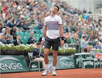  ?? IAN LANGSDON, EPA ?? Defending champion Novak Djokovic, above, was ousted by Dominic Thiem in the French Open quarterfin­als, dropping the final set 6-0.