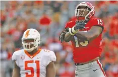  ?? STAFF PHOTO BY C.B. SCHMELTER ?? Tennessee offensive lineman Drew Richmond (51) and Georgia linebacker D’Andre Walker react after Georgia recovered a Vols fumble on Sept. 29.