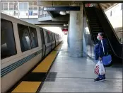  ?? RAY CHAVEZ — STAFF PHOTOGRAPH­ER ?? Rosaura Moreno boards at the North Concord/Martinez Station to ride BART, which has seen ridership vanish.