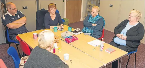  ??  ?? Dundee Mental Health Cairn Fowk group in a meeting.