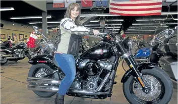  ?? IVAN MORENO/ THE ASSOCIATED PRESS ?? Terri Meehan poses on a 2018 Harley Softail Slim in Milwaukee. Meehan took a riding course at the dealership as part of Harley- Davidson’s Riding Academy, an initiative the company hopes will help bring new customers.