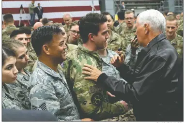  ?? AP/JACQUELYN MARTIN ?? Vice President Mike Pence visits with U.S. troops during a stop today at Ramstein Air Base in Germany. Pence was on his way back from Turkey, where Turkish officials agreed after meeting with Pence and Secretary of State Mike Pompeo to halt an offensive against Syrian Kurdish fighters in northern Syria.