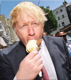  ??  ?? Getting messy: Mr Johnson struggles with his ice cream