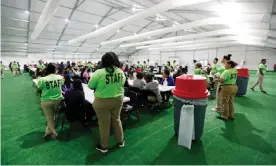  ??  ?? Staff oversee breakfast at the US government’s government’s newest holding center for migrant children in Carrizo Springs, Texas. Photograph: Pool/Reuters