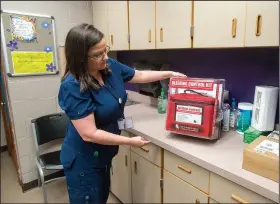  ?? NWA Democrat-Gazette/BEN GOFF • @NWABENGOFF ?? Leah Johns, school nurse, displays a new bleeding control kit Friday in her office at Lowell Elementary School. The unit with five individual kits containing tourniquet­s and trauma dressings, will be wall mounted next to the school’s automated external...