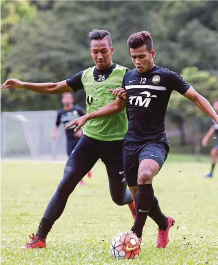  ??  ?? Adam Nor Azlin (left) was hampered by fever prior to Malaysia’s 4-1 defeat against Iraq on Wednesday.