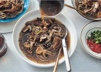  ?? MICHAEL GRAYDON AND NIKOLE HERRI NYT ?? Cooking the mushrooms until they brown concentrat­es their flavour in spicy noodle soup. Soy sauce and rice wine vinegar give the broth its complexity.