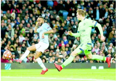  ??  ?? Manchester City’s Raheem Sterling scores his side’s fourth goal during the Champions League round-of-16 second-leg match against Schalke 04 at Etihad stadium in Manchester, England, yesterday.