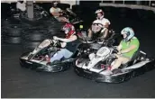  ??  ?? Drivers race around the indoor go-karting track at Action500 in Laval.