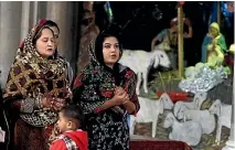  ??  ?? Pakistani Christian women pray during a Christmas mass at Sacred Heart Cathedral in Lahore.