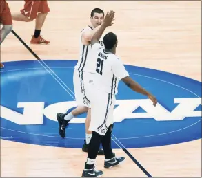  ?? Keith Srakocic / Associated Press ?? Butler’s Andrew Chrabascz, top, and Roosevelt Jones (21) celebrate at center court as time runs down in the second half of an Men’s NCAA Tournament second-round game against Texas in 2015.