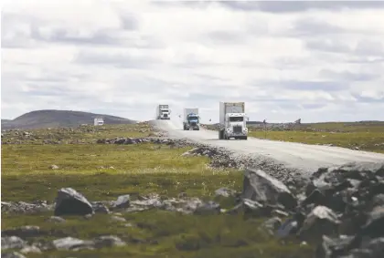  ?? COLE BURSTON/BLOOMBERG FILES ?? Trucks drive along a road near Agnico’s Meadowbank gold complex in Nunavut in July. Agnico CEO Sean Boyd says Canada needs a better conversati­on about how its resources can be tapped to create value for everyone.