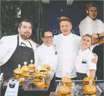  ?? ETHAN MILLER/GETTY IMAGES ?? Chefs Michael Stevenson, left, Christina Wilson, Gordon Ramsay and Agata Siwinska present burgers they created at the Gordon Ramsay burger booth during the 13th annual Vegas Uncork’d.