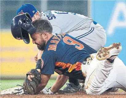  ?? ERIC CHRISTIAN SMITH THE ASSOCIATED PRESS ?? Houston’s Jack Mayfield beats the tag from Blue Jay Eric Sogard after one of his three doubles on Saturday at Minute Maid Park.