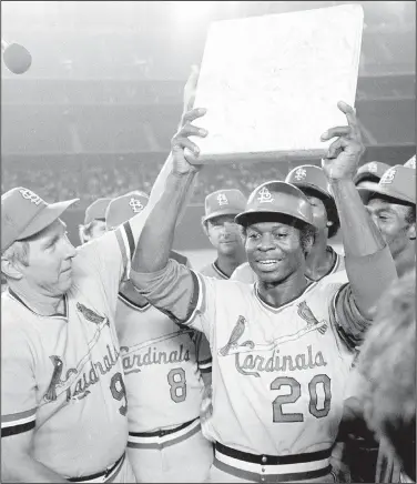  ?? Associated Press ?? Stolen base king: St. Louis Cardinals outfielder Lou Brock, who was born in El Dorado, is surrounded by teammates as he holds second base after breaking Ty Cobb's all-time record of 892 stolen bases during a game against the San Diego Padres in San Diego, Calif., in this Monday, Aug. 29, 1977, file photo. At left is team manager Vern Rapp. The list is disquietin­g in its length - those from the ranks of 1970s baseball rosters who have died in the past year alone.