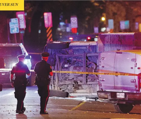  ?? IAN KUCERAK / POSTMEDIA ?? An overturned U-Haul truck is seen in Edmonton on Sunday after an attack on a police officer and several pedestrian­s. A suspect, who is now in custody, used the truck, a car and a knife in multiple crime scenes across the city, police say.