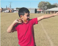  ??  ?? Ezekial Chu, 8, shows off his shot put skills.