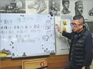  ?? PROVIDED TO CHINA DAILY ?? Sun Xiaocang teaches by writing on the whiteboard at the Cangxiao Studio he and his wife, Xu Weixiao, founded in Xi’an, Shaanxi province.