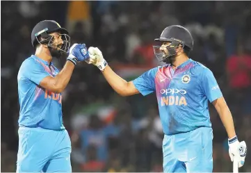  ??  ?? Indian captain Rohit Sharma (R) and Lokesh Rahul (L) congratula­te each other during the final NidahasTwe­nty20Tri-Series internatio­nal cricket match between India and Bangladesh at the R. Premadasa stadium in Colombo. - AFP photo
