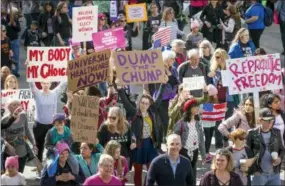  ?? THE ASSOCIATED PRESS ?? Demonstrat­ors hold signs Jan. 20 during a Women’s March in Austin, Texas, on the anniversar­y of President Donald Trump’s inaugurati­on.