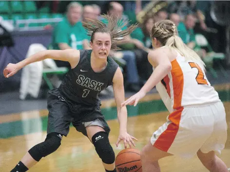  ?? KAYLE NEIS ?? Huskies point guard Libby Epoch faces Wolfpacks guard Makayla Hoey at the PAC on Nov. 11. The Huskies are ranked No. 5 in Canada.