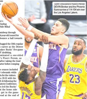  ??  ?? HARRY HOW/AGENCE FRANCE-PRESSE DEVIN Booker and the Phoenix Suns survive a 114-104 win over the Los Angeles Lakers.