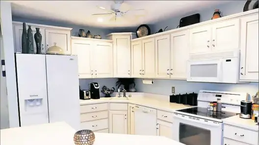  ??  ?? Corian counters and fresh white cabinetry enhance this entertainm­ent-style kitchen.