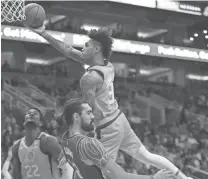  ??  ?? The Suns' Kelly Oubre draws a blocking foul from the Thunder's Steven Adams during the first half at Talking Stick Resort Arena in Phoenix on Friday night.