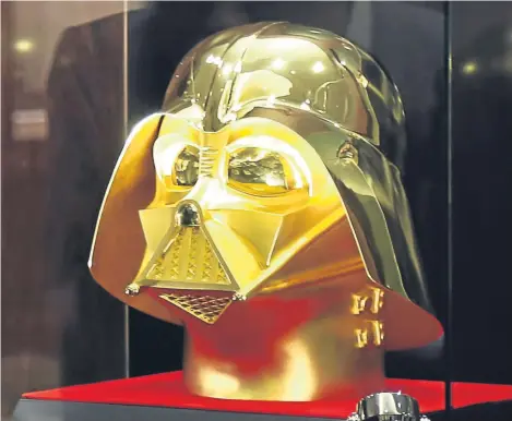  ??  ?? STAR Wars fans have been offered a golden opportunit­y to buy their own 24-karat gold Darth Vader mask — but the force will need to be strong with their bank accounts.
Tokyo jeweller Ginza Tanaka has created a life-size replica of the iconic movie...