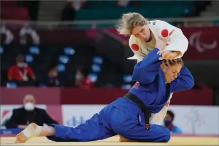  ?? The Associated Press ?? Algeria’s Cherine Abdellaoui, left, fights Canada’s Priscilla Gagne for gold in women’s 52-kg judo at the Paralympic­s, Friday, in Tokyo.