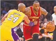  ??  ?? CLEVELAND Cavaliers forward LeBron James (23) heads down the court as Los Angeles Lakers forward Kobe Bryant (24) defends in the first quarter of the game in Los Angeles, California, March 10.
