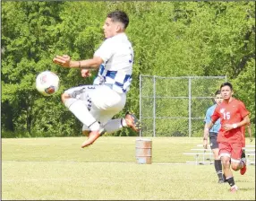  ?? Westside Eagle Observer/MIKE ECKELS ?? Bulldog Andres Revolorio (3) leaps high in the air to intercept a kicked ball from the Jaguar goalie during the Lisa Academy-Decatur second round soccer contest in Harrison Friday afternoon. The Bulldogs lost to Lisa Academy in the 3A state playoffs, 4-2.