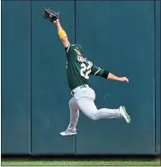  ?? HANNAH FOSLIEN — GETTY IMAGES ?? A’s center fielder Ramon Laureano makes another outstandin­g catch in the fourth inning Sunday.