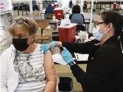  ?? THE NEW YORK TIMES ?? A woman receives her second booster shot at a county health facility in San Jose, California. The Centers for Disease Control and Prevention says those 50 or older should get a second booster shot if at least four months have passed since their first.