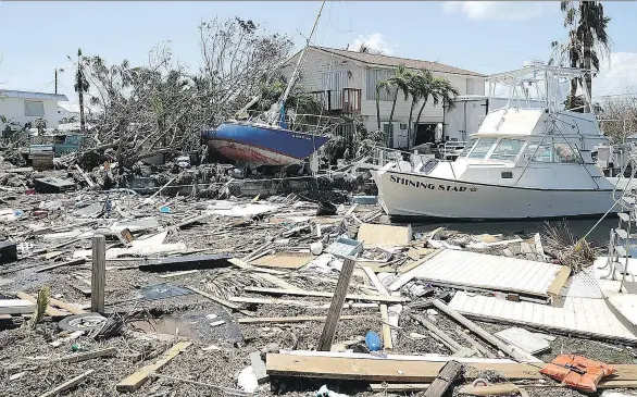  ?? CHIP SOMODEVILL­A/GETTY IMAGES ?? Boats, cars and other debris clog waterways in the Florida Keys on Wednesday in the wake of hurricane Irma. Irma is expected to incur one of the biggest losses from a storm in history, estimated at US$20 billion to US$65 billion. Property owners...