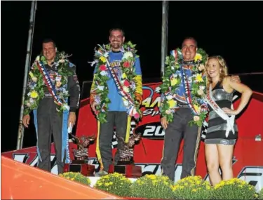  ?? SUBMITTED PHOTO - RICK KEPNER ?? The top 3 finishers of the Freedom 76, Jeff Strunk, center, Craig Von Dohren, left, and Rick Laubach, alongside ‘Miss Grandview’ Taylor Rogers, granddaugh­ter of track owner Bruce Rogers, stand atop the podium following Saturday night’s marquee event.