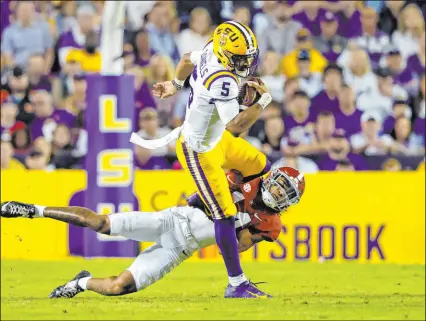  ?? The Associated Press ?? Tyler Kaufman
Alabama safety Brian Branch tries to tackle Louisiana State quarterbac­k Jayden Daniels during the Tigers’ 32-31 overtime win Saturday at Tiger Stadium. Daniels threw for two TDS and ran for a score.