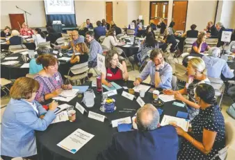  ?? STAFF PHOTO BY DOUG STRICKLAND ?? Attendees talk in discussion groups Thursday during an update on the Chattanoog­a 2.0 initiative on the campus of the University of Tennessee at Chattanoog­a.