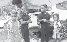  ?? PHOTO BY ADRIAN FRATER ?? Students wait while their parents are being processed within the zone of special operations in Mount Salem yesterday.