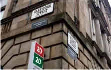  ??  ?? Activists placed alternativ­e street sign names in the city centre underneath those with links to slavery