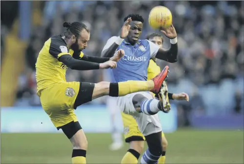  ??  ?? Sheffield Wednesday’s Lucas Joao, right, tangles with Burton Albion’s former Sheffield United player John Brayford.