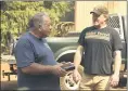  ??  ?? Reed Rankin, volunteer fire chief of Berry Creek, receives a box of cigars from James “Woody” Faircloth on Sunday Oroville.