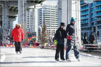  ?? Canadian Press photo ?? Members of the local community skate during a media preview of the Bentway Skate Trail, a 220-metre ribbon of ice running under a section of the Gardiner Expressway in Toronto, on Friday.